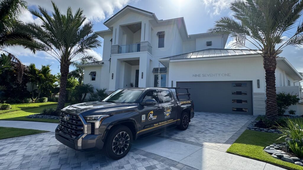 18-foot by 8-foot modern gray flush-panel garage door with side windows installed by Eddie's Garage Door on a Southwest Florida home